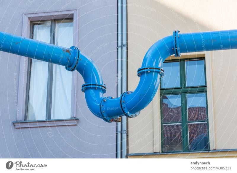 The blue water pipe connects two houses architecture building city communication community connector construction contact cooperation design difference