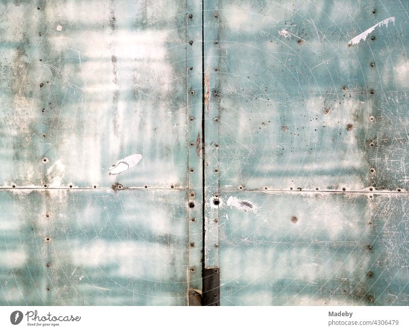Rust and patina on riveted metal sheets in pastel colours of an old sales trolley at the weekly market in Oerlinghausen near Bielefeld in the Teutoburg Forest in East Westphalia-Lippe