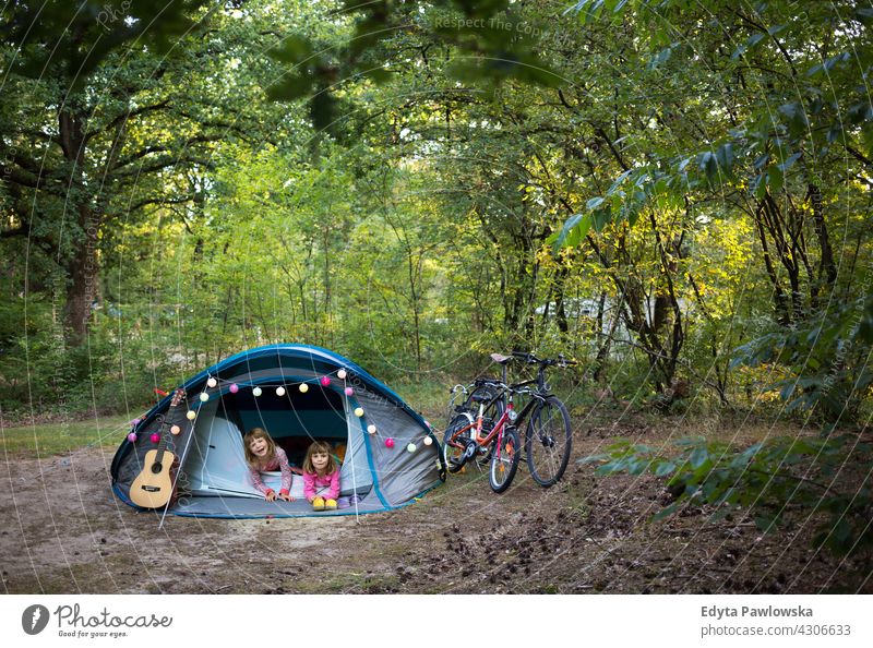 First Time Camping hiking cycling vacation holiday bike bicycle tent forest children kids family camping happy smiling night evening sleeping trek trekking