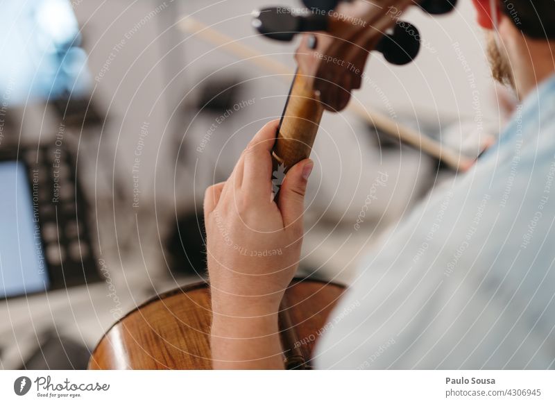Close up hand holding a cello Cello Music Musician Musical instrument Interior shot Colour photo Musical instrument string Concert String instrument Orchestra