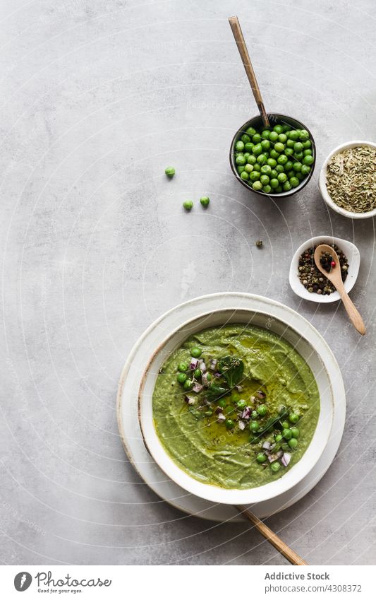 Vegan peas cream healthy soup dinner green vegetarian bowl vegetable meal food diet cuisine lunch fresh appetizer homemade cooking spoon tasty delicious dish