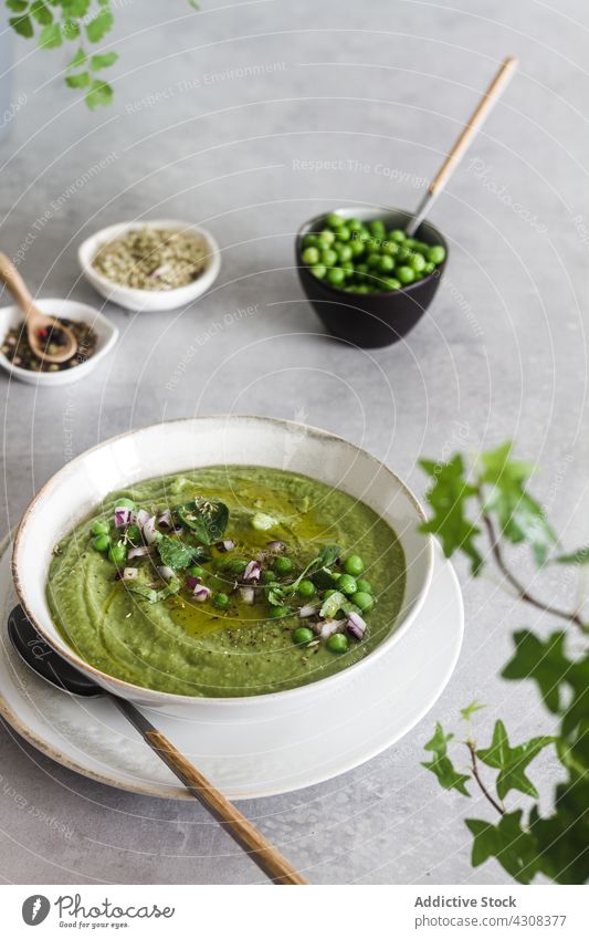 Vegan peas cream healthy soup dinner green vegetarian bowl vegetable meal food diet cuisine lunch fresh appetizer homemade cooking spoon tasty delicious dish