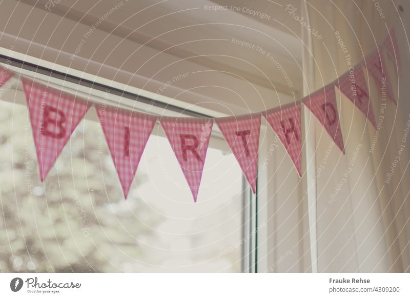 Partial view of a Happy Birthday pennant chain on a curtain rod celebrate a birthday Feasts & Celebrations Interior shot Party Pink Decoration