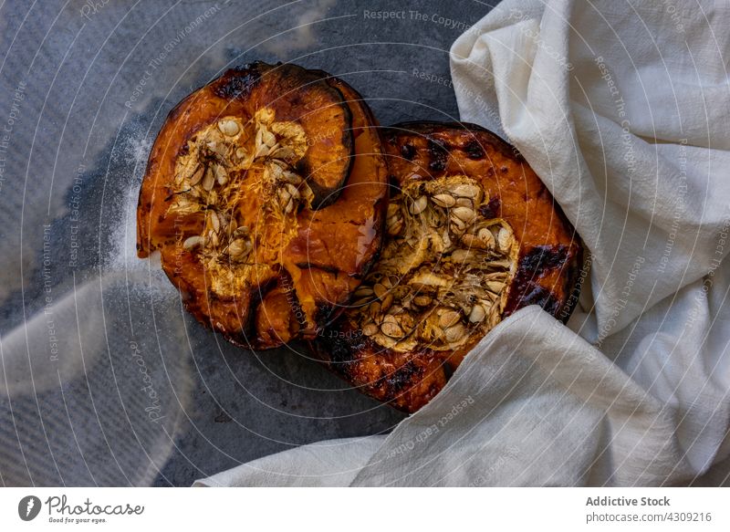 Baked pumpkin on table with cloth baked food healthy vegetarian vegetable half nutrition natural cuisine delicious homemade meal tasty organic tradition kitchen