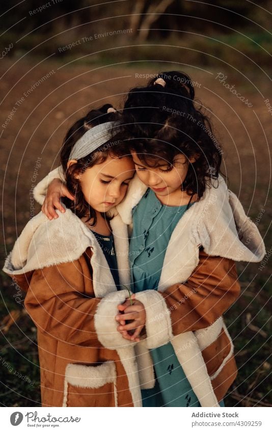 Little girls hugging in countryside sister embrace love together kid sibling cute relationship close similar child children little adorable childhood bonding