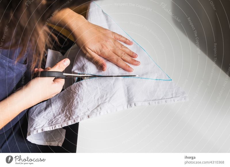 woman's hands using sewing scissors Equipment closeup cloth clothing costuming craft creative creativity design domestic dress dressmaker fabric handicraft