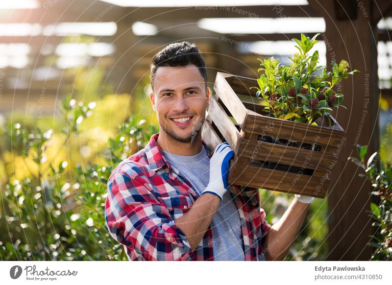 Man working in garden center outdoors day Caucasian toothy smiling enjoying summer fall autumn outside positivity nature gardening cultivate grow growth hobby