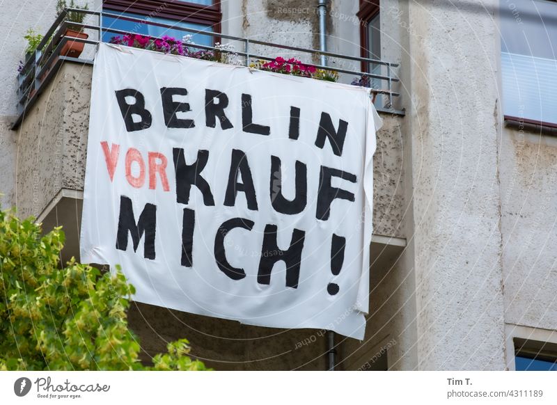 A banner hangs in front of a balcony protest Berlin Balcony Prenzlauer Berg Shopping myself Town Capital city Downtown Exterior shot Deserted Old town Day