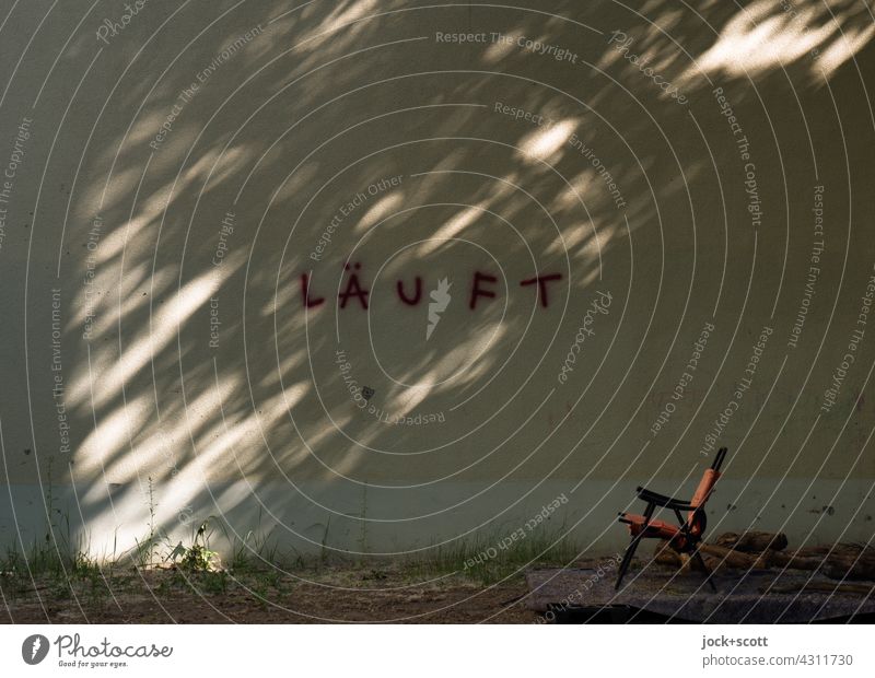 RUNS a play of light in the shade now also in summer Backyard Fire wall Facade Word Spray Silhouette Structures and shapes Capital letter Street art German