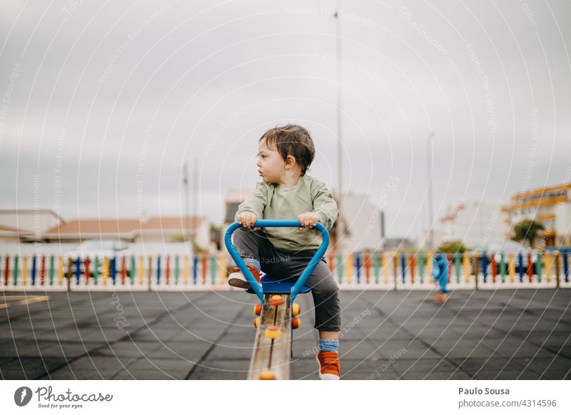 Child playing in the playground childhood Caucasian 1 - 3 years Playing Playground Kindergarten Day Exterior shot Leisure and hobbies Human being Lifestyle