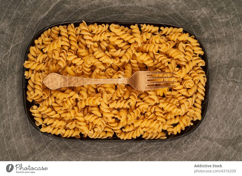 Cutlery and raw pasta on tray fork knife table fusilli lunch mockup composition food cuisine meal utensil kitchen italian culinary dinner cutlery ingredient