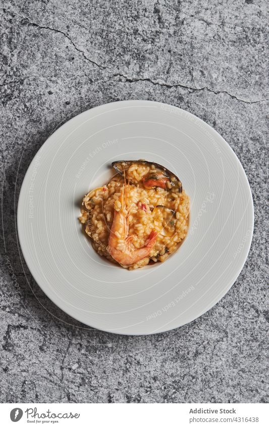 Rice with seafood on plate rice paella dish restaurant serve meal delicious cuisine tasty spanish food spanish cuisine table gourmet culinary shrimp calm