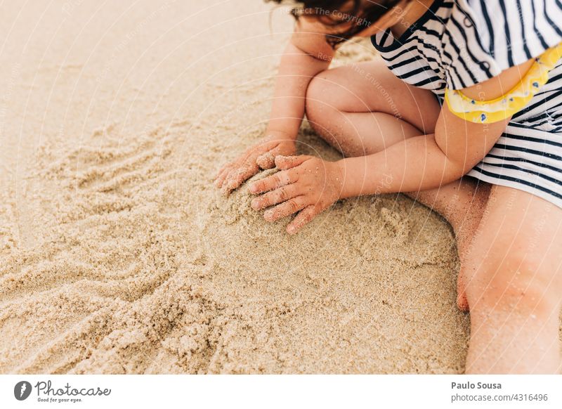 Child playing with sand at the beach 1 - 3 years Playing Beach Sand Sandy beach Authentic Ocean Day Toddler Joy Summer vacation Vacation & Travel Exterior shot