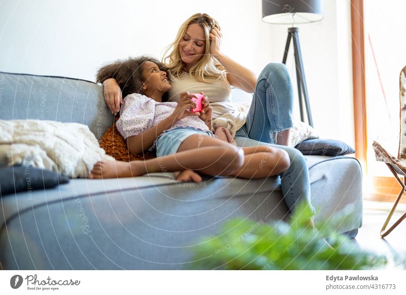 Mother and daughter together at home mother child family multi-ethnic mixed race family diverse family diversity afro real people millennial hair girl children