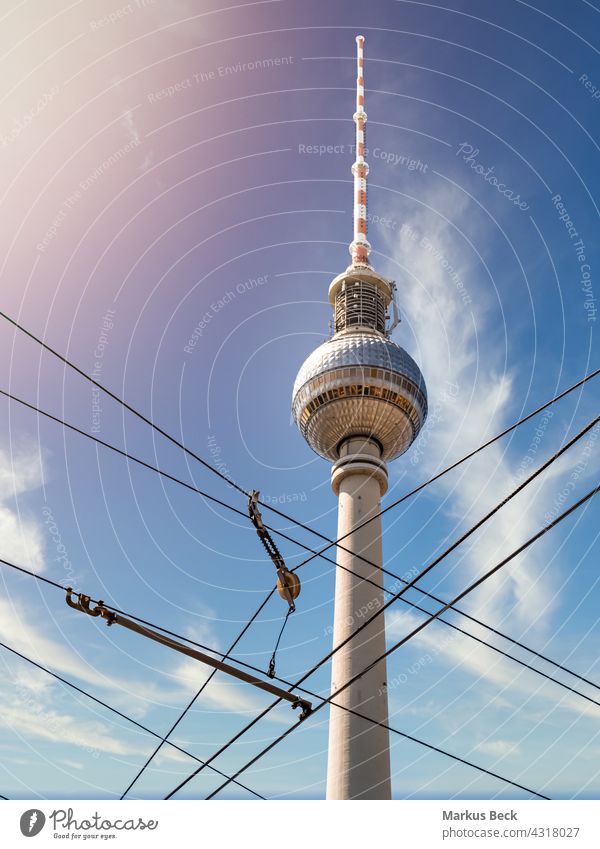 Berlin Television Tower from low angle with cable in forefront during summer with sunflare, germany berlin television alexanderplatz tower architecture
