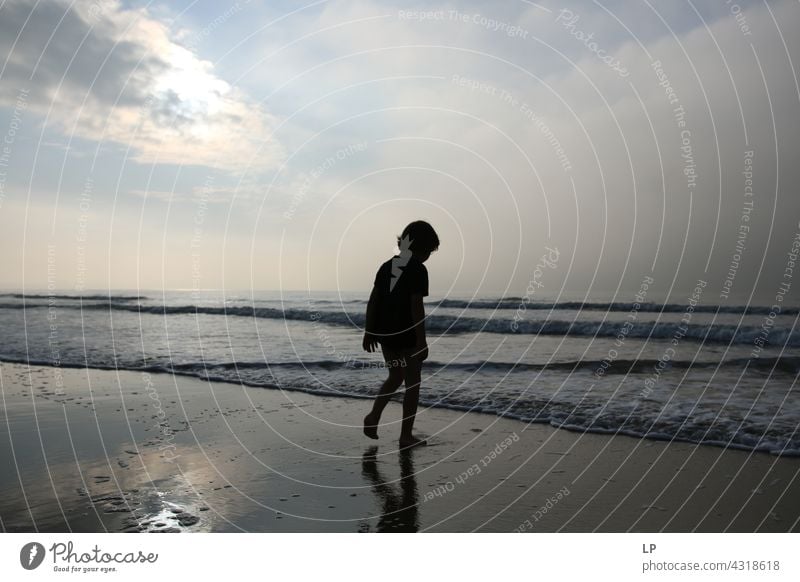 contrast silhouette of a child walking towards the sea and sky outdoor recreation Structures and shapes Education Playing Pacific Ocean ocean beach Lifestyle
