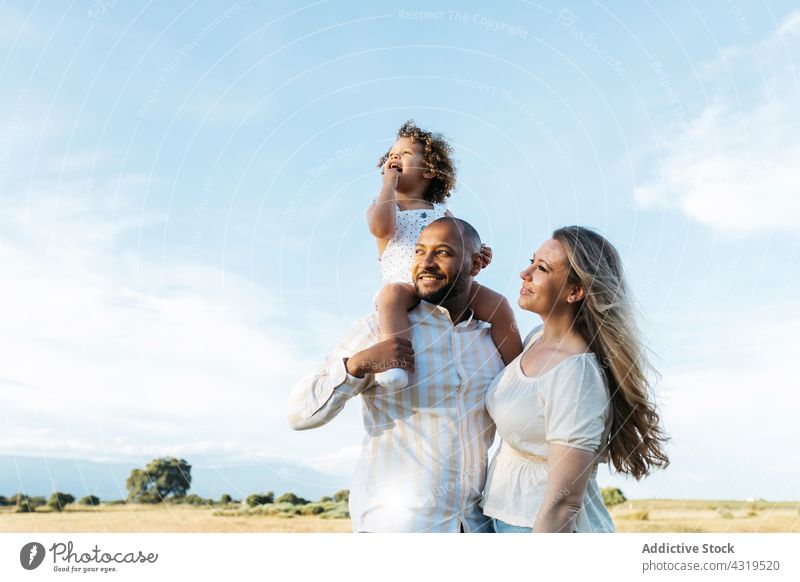Content multiracial family in summer field together unity child happy enjoy nature daughter multiethnic diverse black african american mother childhood kid