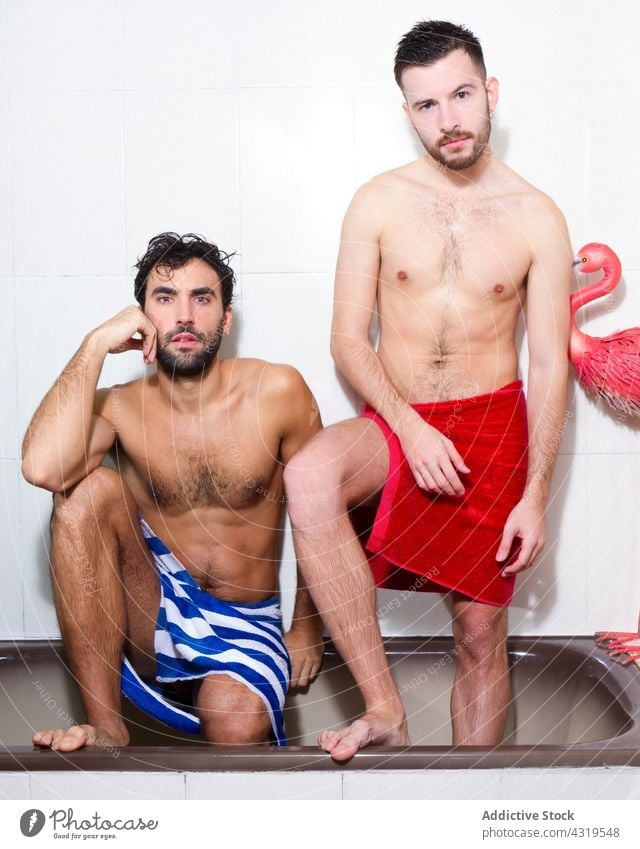 Diverse homosexual men in bathtub couple gay bathroom together lgbt love relationship multiethnic multiracial diverse boyfriend intimate confident naked torso