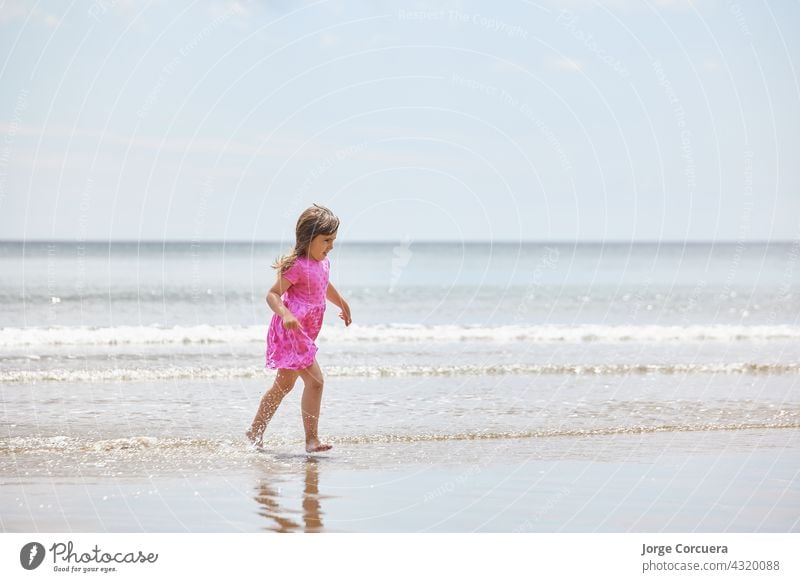 Adorable toddler girl playing with beach on white sand beach adorable kid summer young child childhood sea person cute caucasian lifestyle tropical coast people