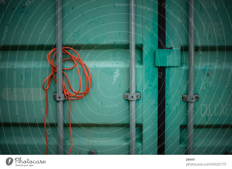 Gaps | An orange cable is jammed on a green container Spaces Spacing Cable Orange Container Green overseas Container ship Container terminal Container cargo