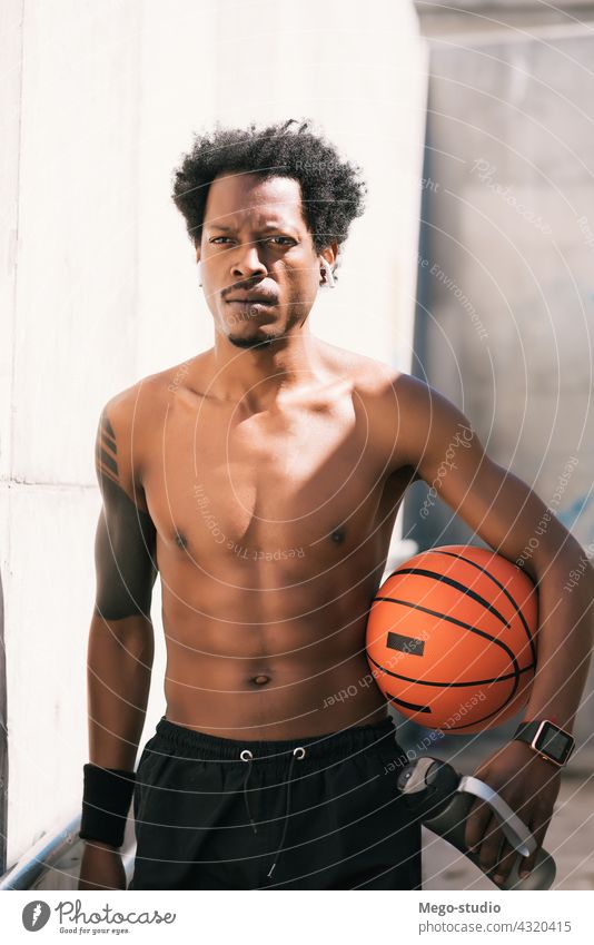 Afro athlete man holding a basketball ball outdoors. sport urban athletic standing enjoy expression active hand exercise recreation sports fitness sportive