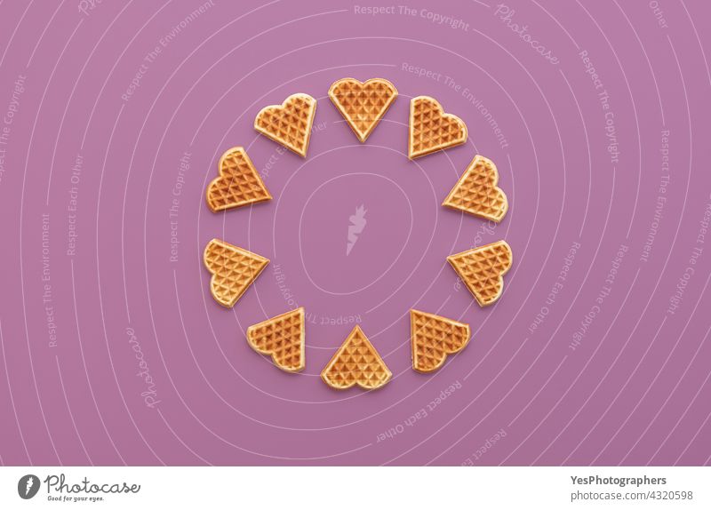 Heart shaped waffles top view on a purple background above aligned arranged baked bakery belgian belgium breakfast circle color copy space cuisine cut out day