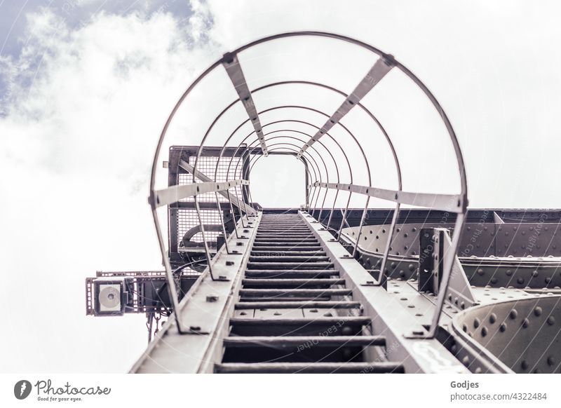 Steel fire escape on a bridge, view to the sky Ladder Rung Exterior shot Deserted Upward Colour photo Day Stairs Wall (building) Go up Sky Copy Space top Tall