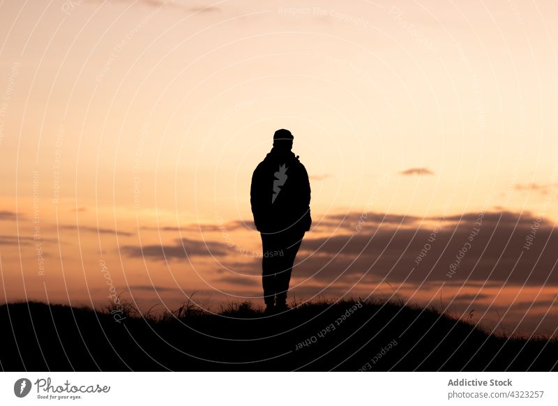 Silhouette of a man from behind looking at the sunset silhouette nature sky person travel people landscape sunrise outdoor beautiful summer young orange freedom
