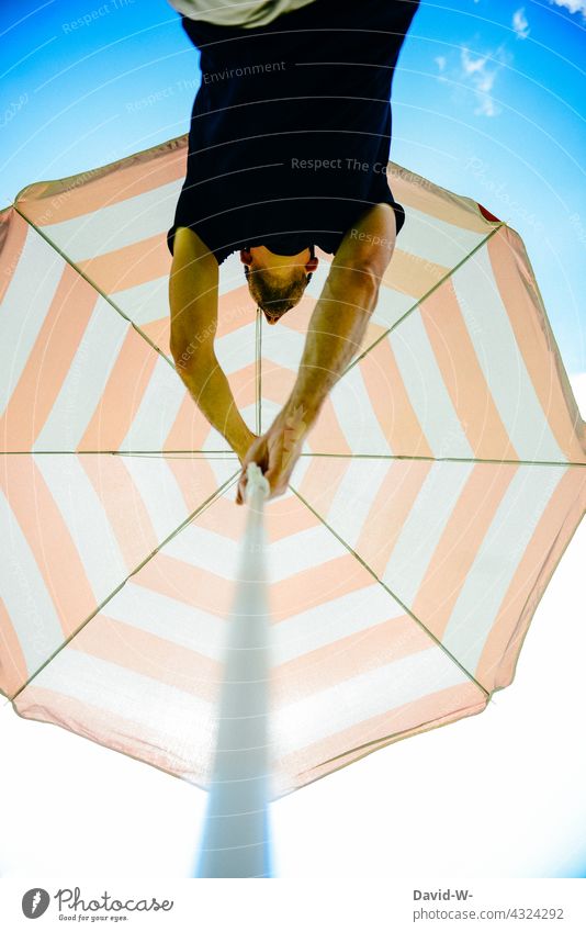 Man puts up a parasol Summer Sunshade sunshine vacation Sunlight Relaxation shade dispenser Blue Sky