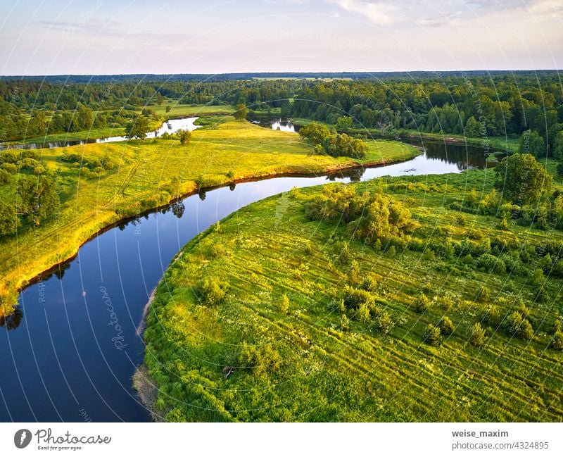 Aerial view of river in green meadows, beautiful sunset light. Meander evening panorama summer landscape nature tree aerial forest water oak background grass