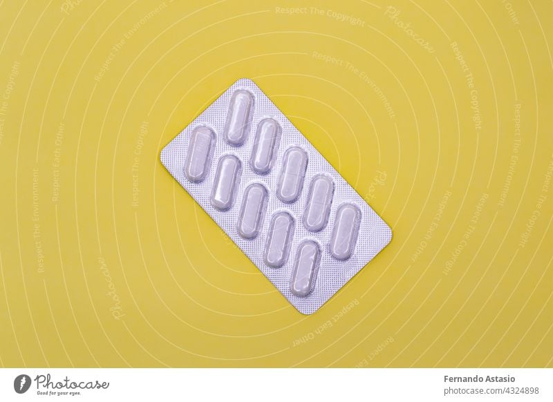 Pack of white pills on a yellow background. Horizontal photography. medicine health card tablet medical pharmacy object drug tablets care capsule healthcare