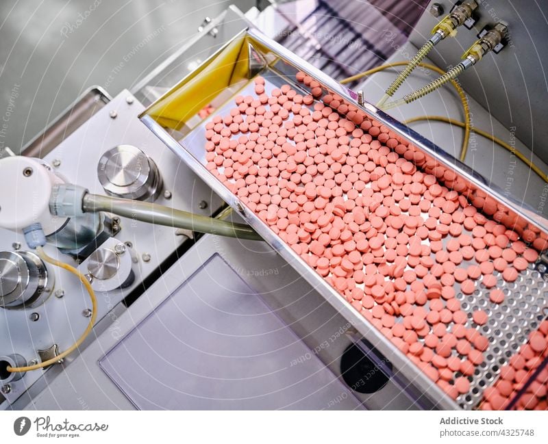 Modern pharmaceutical machine with pills at factory conveyor manufacture laboratory machinery production medicine equipment industry professional technology
