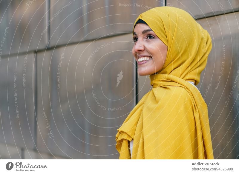 Stylish Muslim woman in yellow headscarf in city hijab style trendy smile charming appearance tradition female ethnic muslim street culture religion elegant