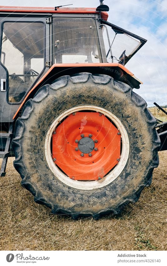 Modern tractor placed on agricultural field in mountainous area in summer tire wheel vehicle agriculture machine equipment transportation industrial machinery