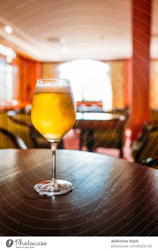 Glass of beer alcohol ale appetizer bar beverage bokeh brewery cold concept craft drink foam food glass golden pub selective focus snack table thirsty vintage
