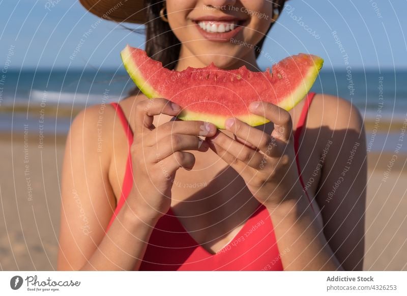 Content woman eating watermelon on beach summer vacation sea bikini holiday cheerful female enjoy swimwear smile fresh swimsuit tasty seashore delicious happy