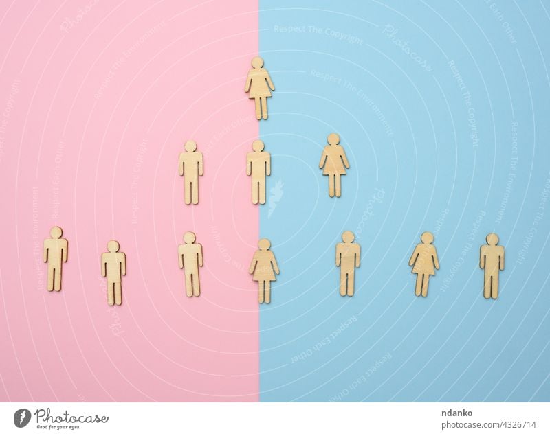 wooden figures on a blue pink background, hierarchical organizational structure of management, effective management model in the organization subordination
