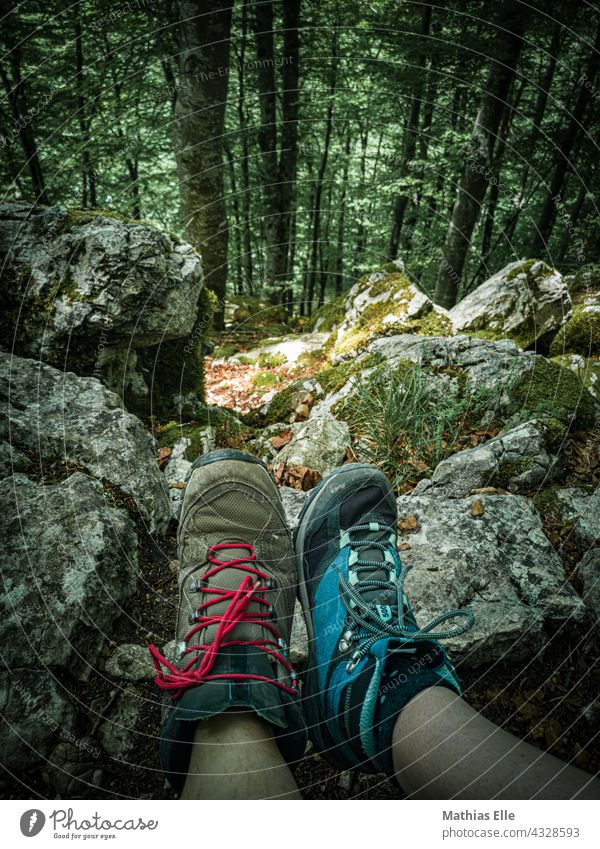 2 people hiking show their hiking boots Footwear Hiking Forest Hiking boots trekking stones Rock forest path Woodground hiking gear free time Freedom leg Legs