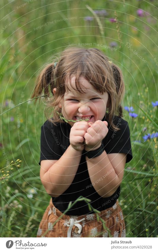 girl stands in the meadow and crosses her fingers Girl cross one's fingers Fist Firm Show your teeth Black Hand Human being Close-up Dark Flower meadow flowers