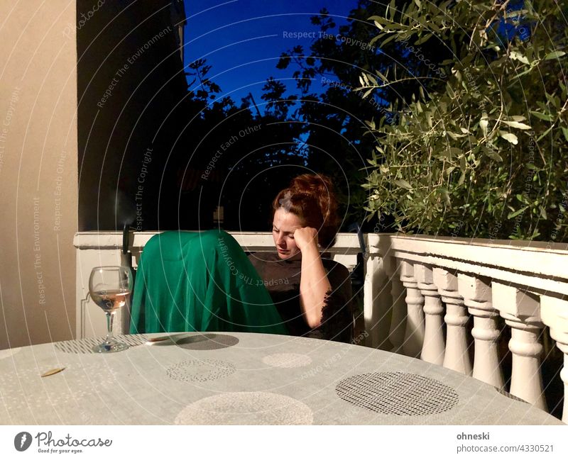 Thoughtful woman with wine glass on summer terrace in the evening Woman Meditative Dark-haired Adults 30 - 45 years Summer Wine glass blue hour Dusk Terrace
