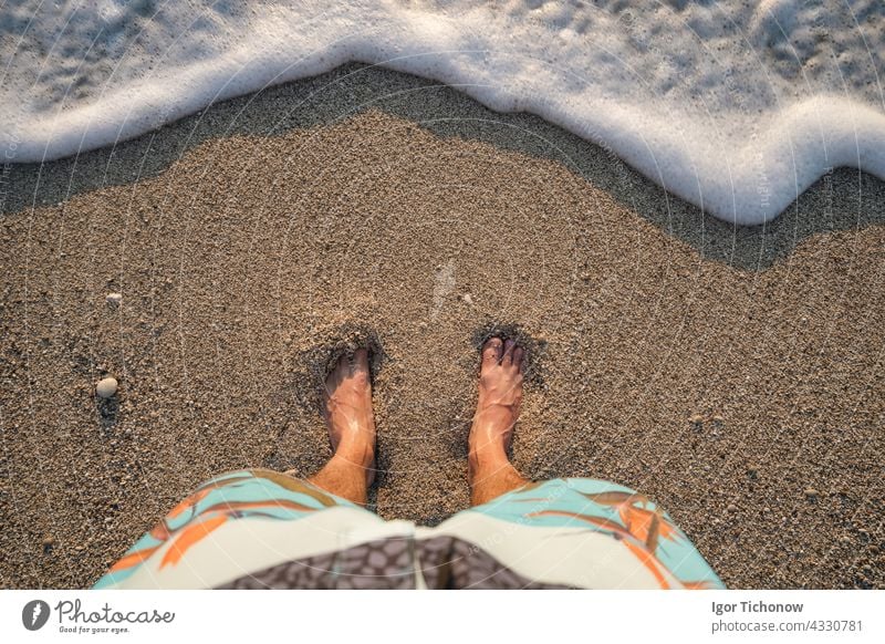 Foot on Milos beach top view POV. Lefkada Ionian island, Greece ionian barefoot toes feet greece person people foam levkada Agios Nikitas milos waves sunset