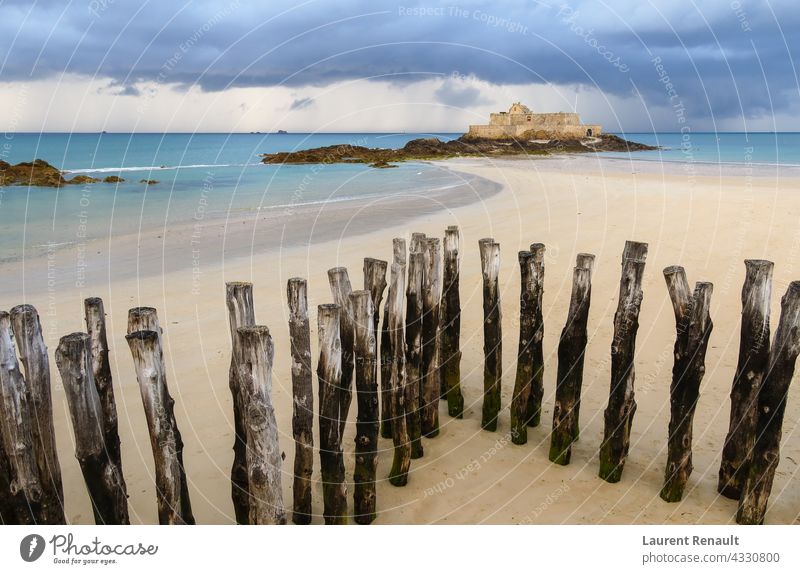 Fort National in Saint-Malo and breakwater trunks at eventail beach France bretagne brittany coastline fort island landscape malo national saint saint-malo sea