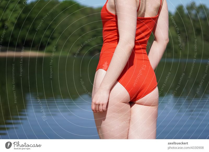 young woman in red swimsuit at the lake Swimsuit Red swimwear Rear view Unrecognizable Swimming lake Lake Stand Swimming & Bathing Leisure and hobbies vacation