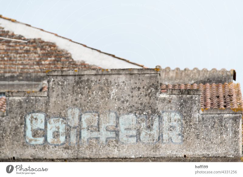 faded notice 'Coiffeur' on an old town facade lettering hairdresser Old town Historic Buildings Tracks track search Decline dilapidated building Architecture