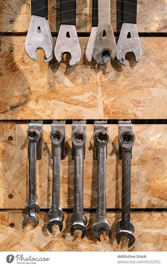 Assorted tools hanging on wall in workshop repair service instrument assorted various garage metal equipment set collection toolkit steel shabby object detail