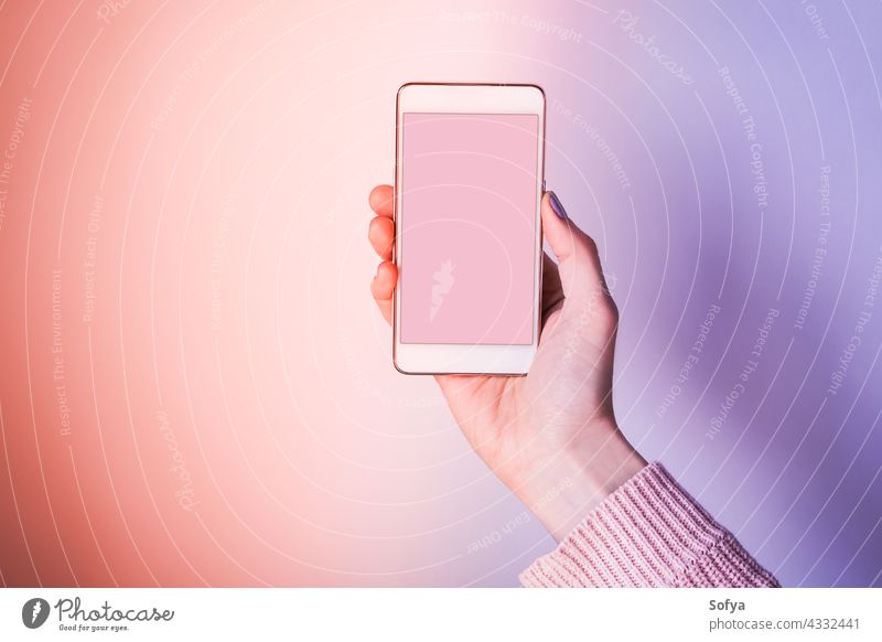 Hand with mobile phone screen on pink and purple hand background violet smartphone device ultra coral woman copy space invitation application website internet