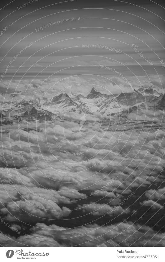 #A# Camera upthrow Mountain mountains Mountain range Clouds Clouds in the sky View from the airplane Airplane window Sky Landscape Exterior shot Alps Peak
