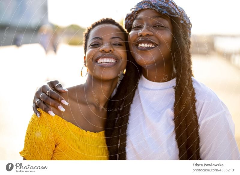 Portrait of two beautiful women standing together outdoors diversity millennials friends friendship sisterhood black live matter afro proud real people candid