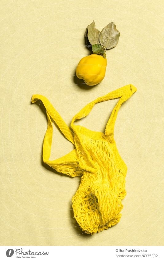 Quince apple and yellow mesh bag flat lay on linen natural quince shopping ripe leaf vitamin nature nutrition organic vegetarian quince fruit raw reusable
