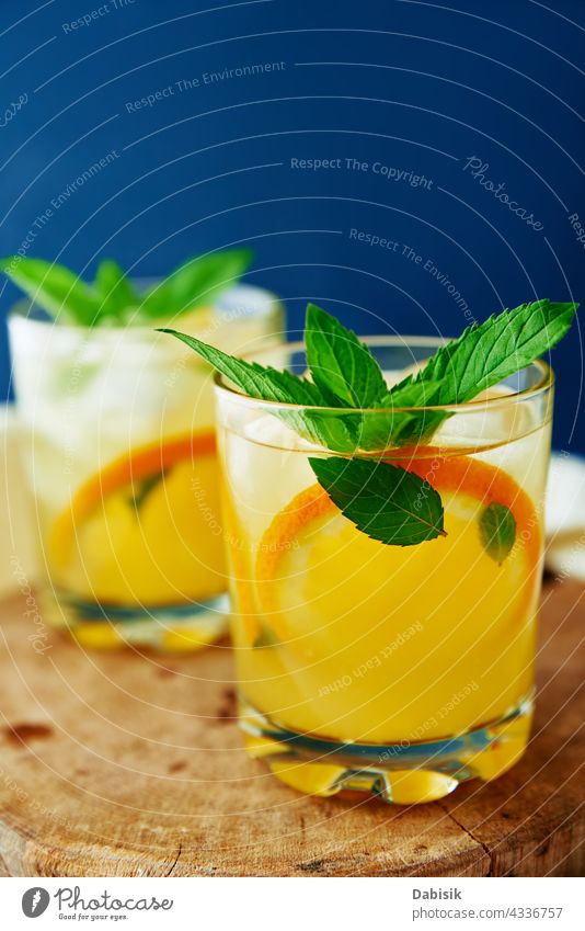 Orange fresh lemonade in glass on dark background drink orange summer cold citrus water fruit refreshing mint blue vitamin detox ice table beverage summer drink